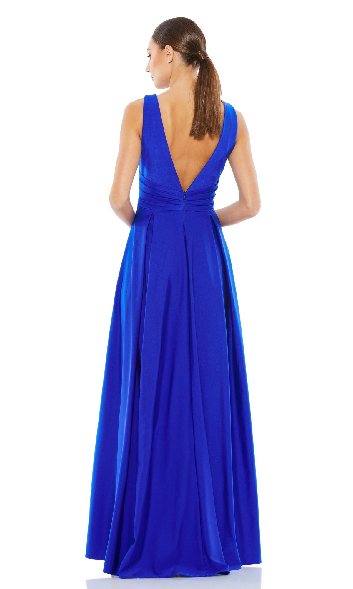 Woman with brown hair in a low ponytail stands facing away, wearing a sleeveless, floor-length bright blue Mac Duggal 26578 V-Neck Long A-Line Prom Dress with a deep V-back.